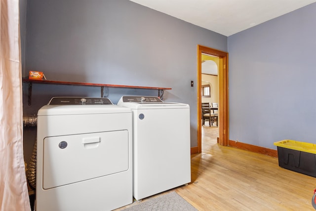 laundry room featuring light hardwood / wood-style flooring and separate washer and dryer