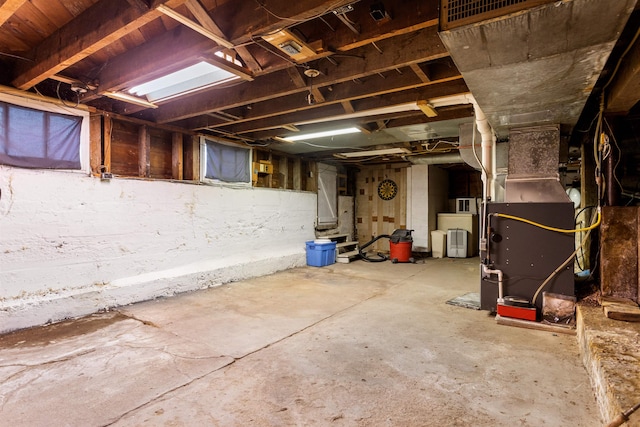 basement featuring heating utilities and washer / dryer