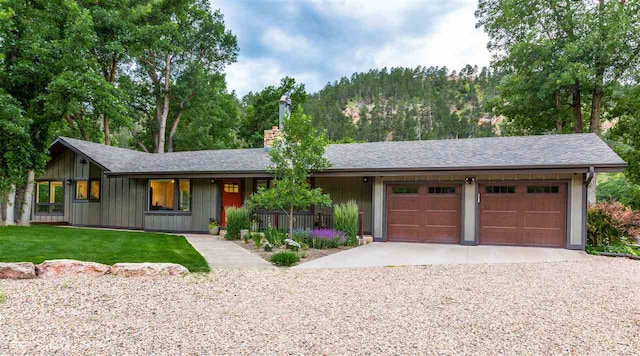 ranch-style home featuring a garage and a front yard