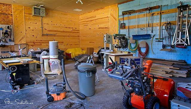 garage featuring a workshop area and wooden walls