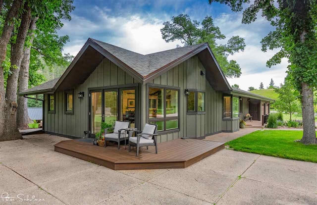 back of house with a yard and a deck