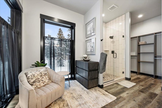 full bathroom featuring recessed lighting, wood finished floors, visible vents, baseboards, and a stall shower