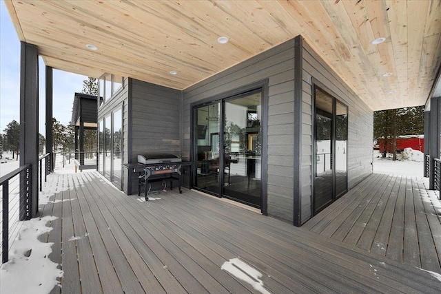 snow covered deck featuring grilling area