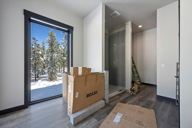 entryway featuring baseboards, visible vents, wood finished floors, and recessed lighting