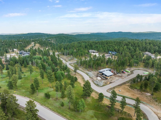 drone / aerial view with a mountain view and a forest view