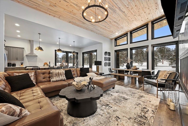 living area with wooden ceiling, plenty of natural light, and wood finished floors