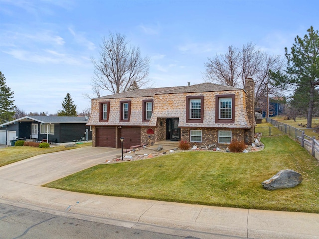 raised ranch with a front yard and a garage