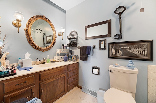 bathroom with tile floors, vanity, and toilet