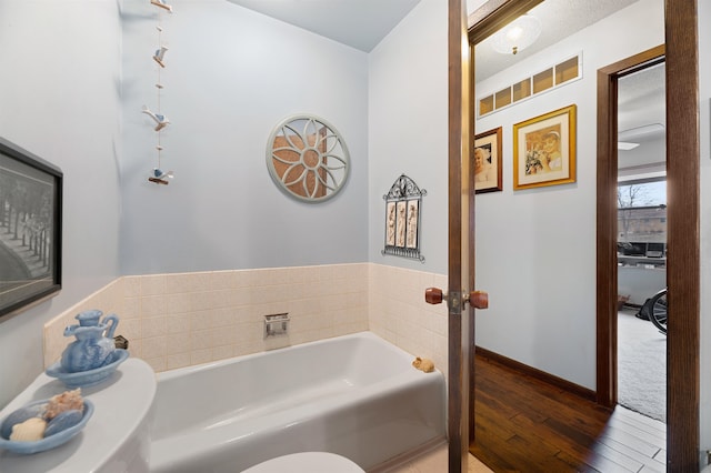 bathroom featuring hardwood / wood-style floors and a washtub