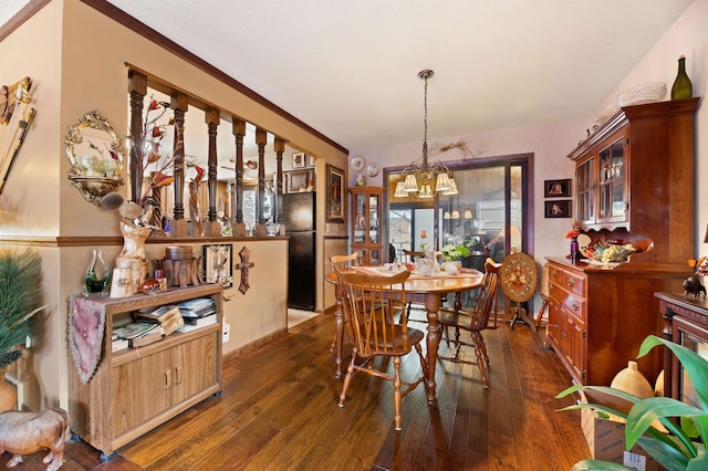 dining room featuring dark hardwood / wood-style floors and an inviting chandelier