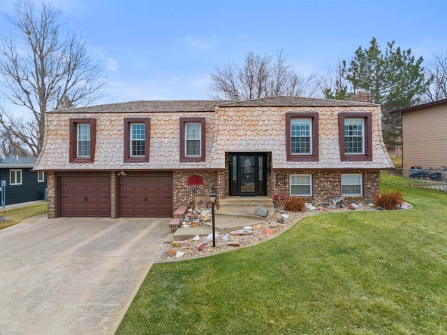 bi-level home featuring a front lawn and a garage