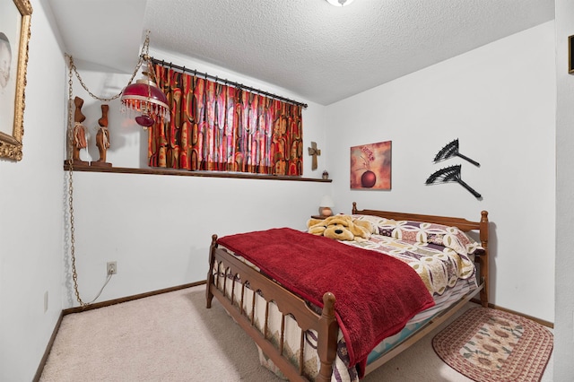 carpeted bedroom featuring a textured ceiling