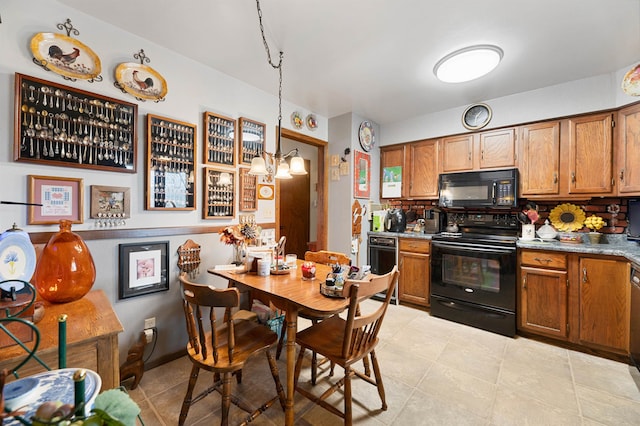 kitchen with decorative light fixtures, light tile floors, and black appliances