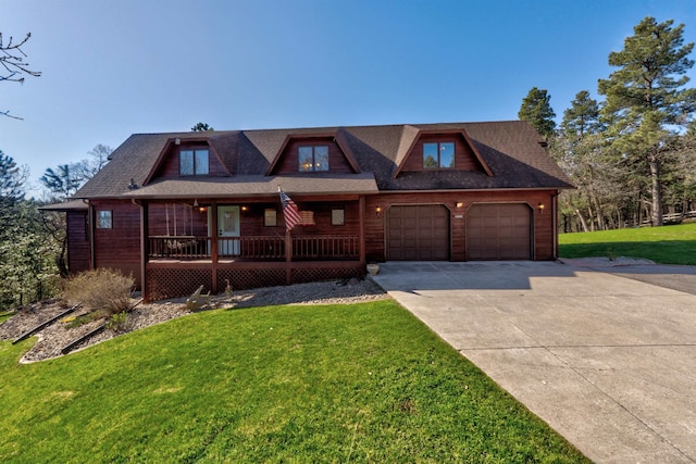 view of front of house featuring a garage and a front lawn