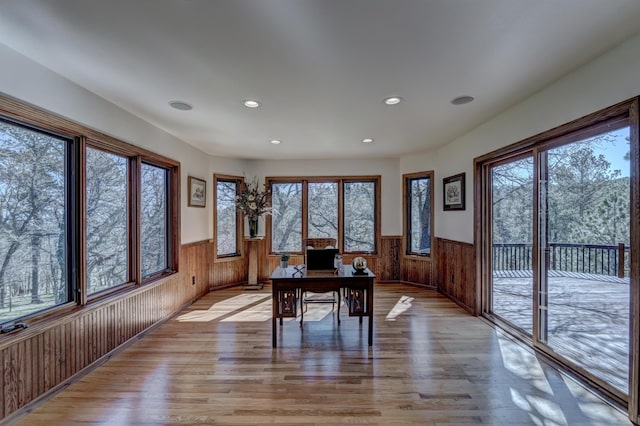 office featuring wood walls and light hardwood / wood-style floors