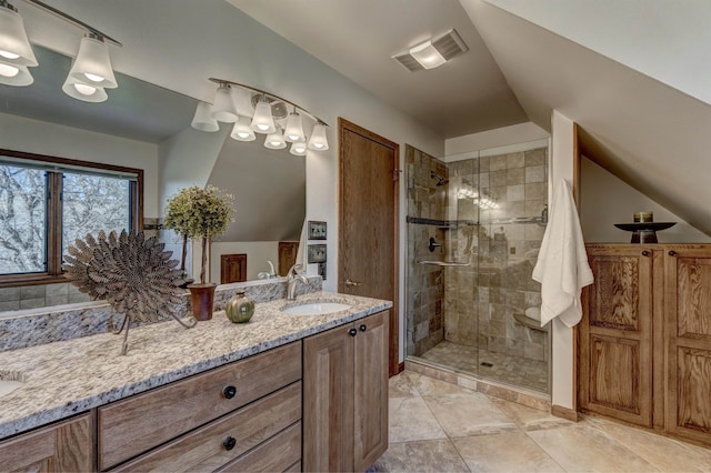 bathroom with tile flooring, an enclosed shower, and vanity