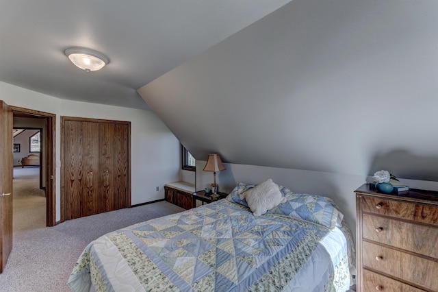 carpeted bedroom with lofted ceiling