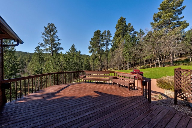 wooden deck with a lawn