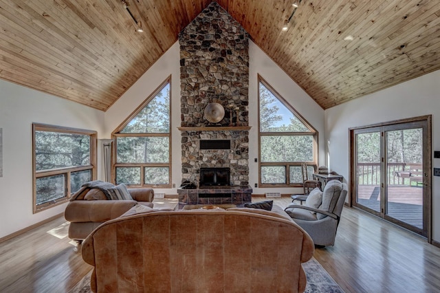 living room featuring plenty of natural light, wood ceiling, and wood-type flooring