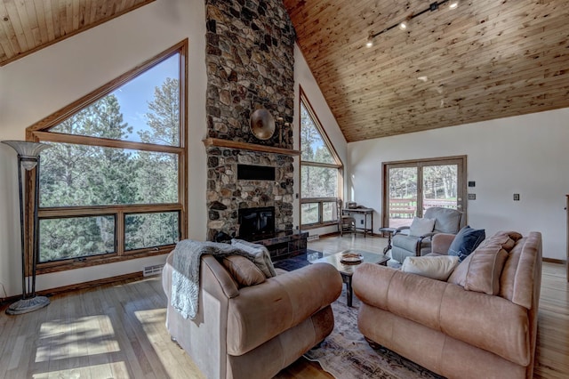 living room with a stone fireplace, high vaulted ceiling, wood-type flooring, and wooden ceiling