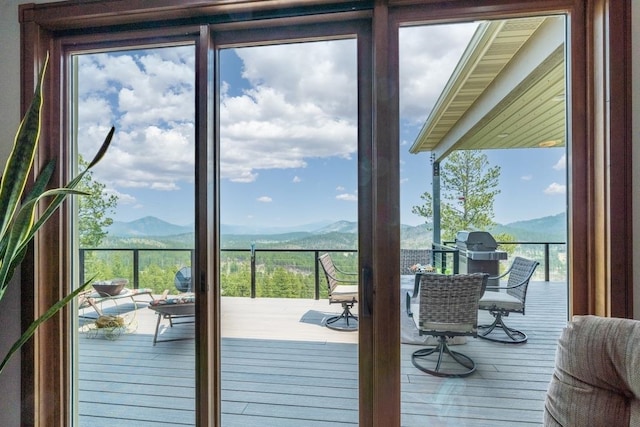 doorway with a wealth of natural light and a mountain view