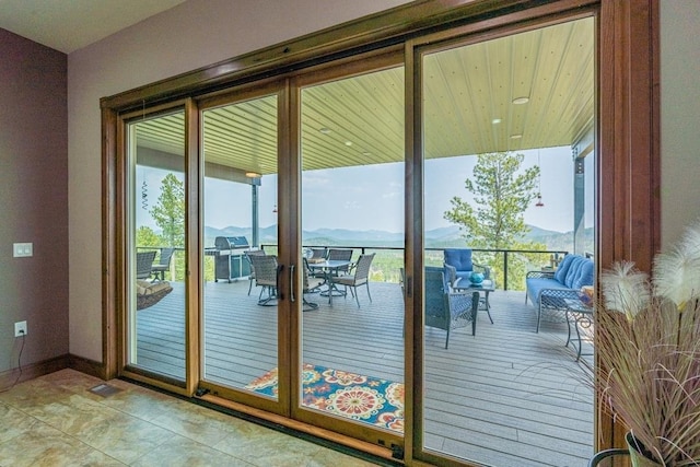 doorway to outside with tile flooring and a mountain view