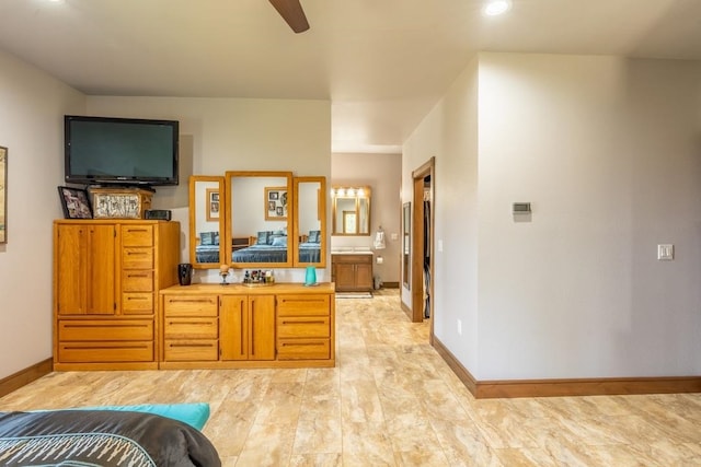 tiled bedroom with ensuite bathroom and ceiling fan