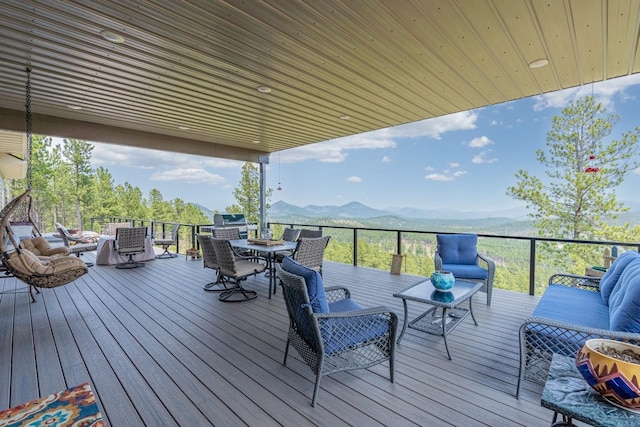 wooden deck featuring outdoor lounge area and a mountain view