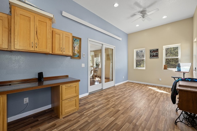 office with hardwood / wood-style flooring, ceiling fan, and french doors