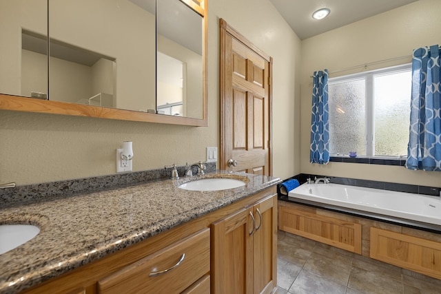 bathroom with tile flooring, oversized vanity, and a bathtub