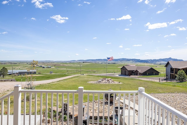 exterior space with a yard, a mountain view, and a rural view