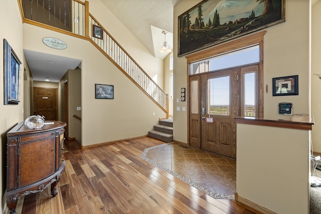 tiled foyer entrance featuring a high ceiling