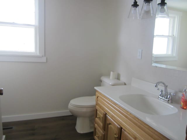 bathroom featuring hardwood / wood-style floors, vanity, and toilet