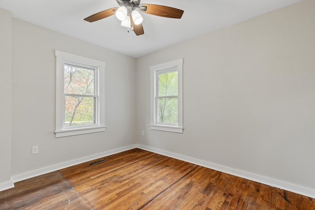 spare room featuring wood-type flooring and ceiling fan