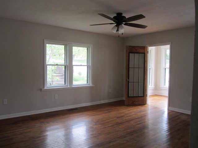 unfurnished room with ceiling fan and dark hardwood / wood-style flooring