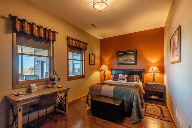 bedroom with dark hardwood / wood-style flooring