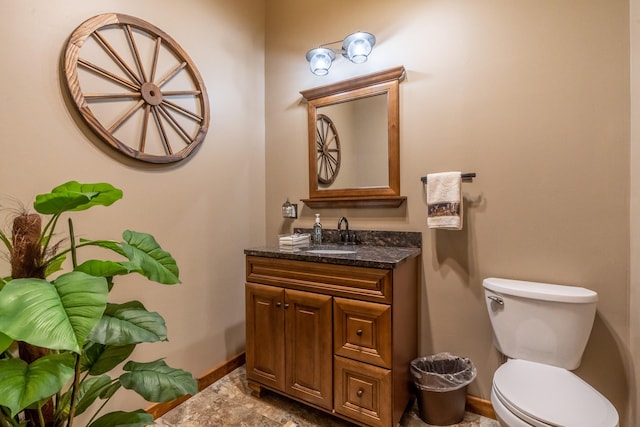 bathroom with vanity, toilet, and tile floors