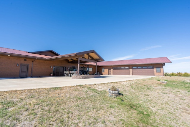 view of front of property with a front yard and a garage