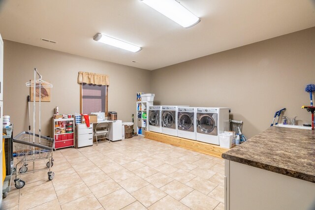 laundry area with tile flooring and washer and clothes dryer