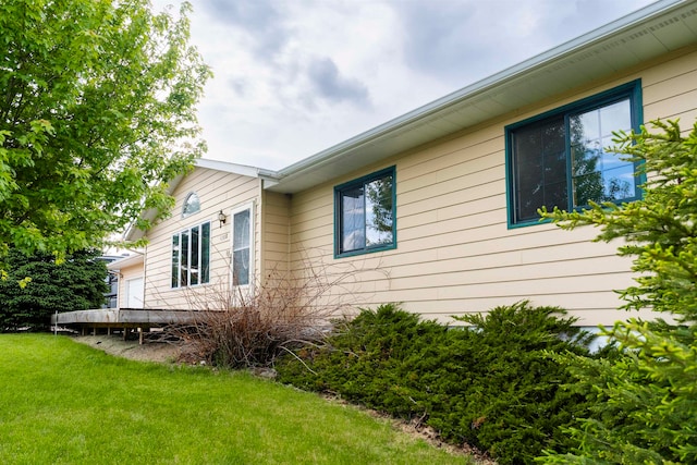 view of side of property with a yard