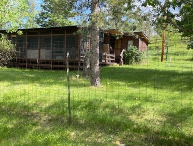 rear view of property with a yard