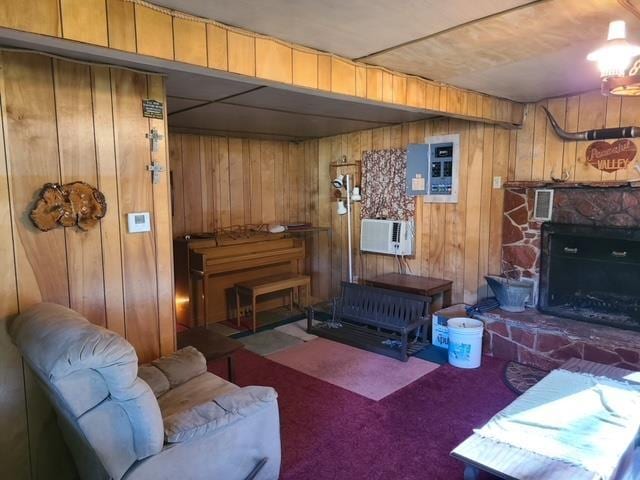 living room with a wall mounted air conditioner, electric panel, wooden walls, a fireplace, and carpet