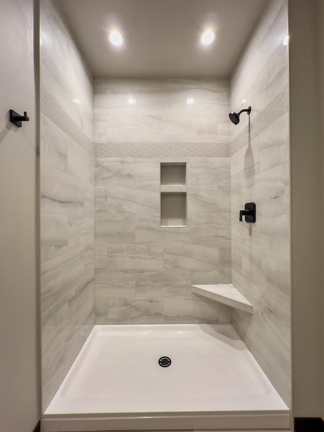 bathroom with tiled shower