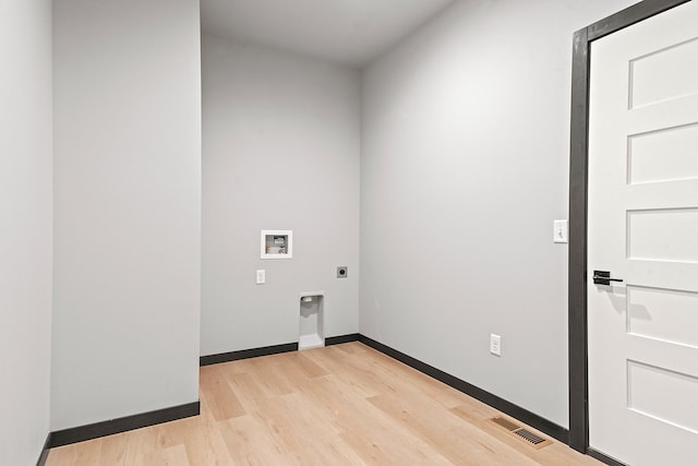 washroom with electric dryer hookup, washer hookup, and light hardwood / wood-style flooring