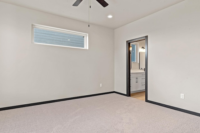 carpeted spare room with ceiling fan