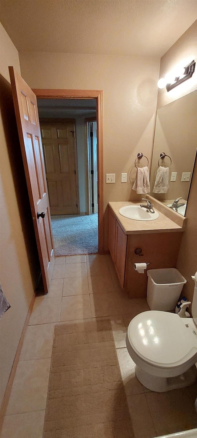 1013 Gladys St, Rapid City, SD 57701 - bathroom featuring tile floors, a textured ceiling, vanity, and toilet