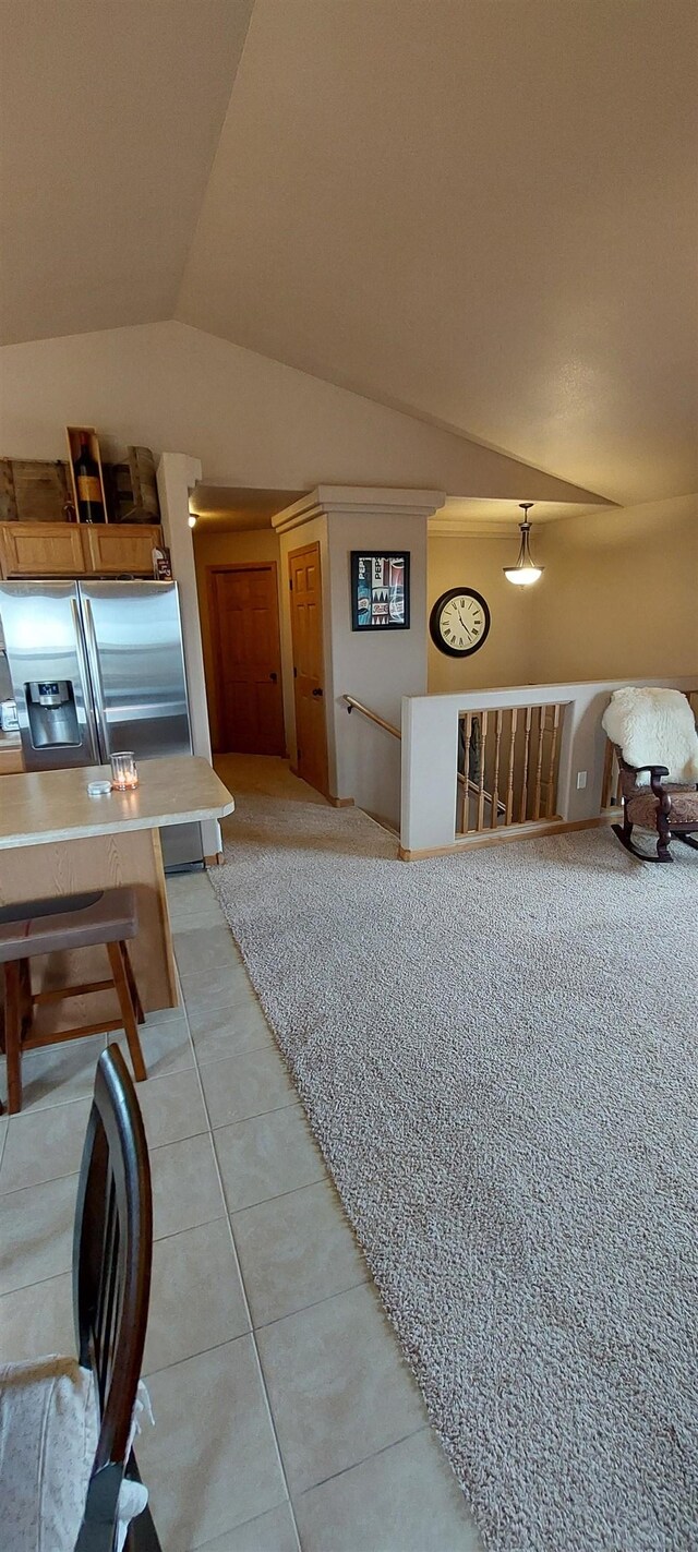 1013 Gladys St, Rapid City, SD 57701 - kitchen with tile flooring, stainless steel fridge with ice dispenser, and lofted ceiling