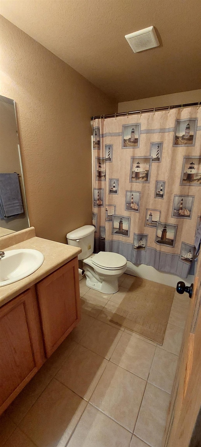 1013 Gladys St, Rapid City, SD 57701 - bathroom featuring a textured ceiling, vanity, toilet, and tile floors