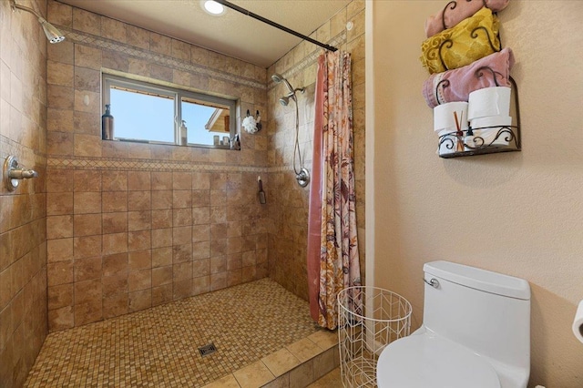 bathroom featuring tile patterned floors, toilet, and a shower with shower curtain