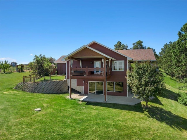 rear view of house with a lawn and a patio area